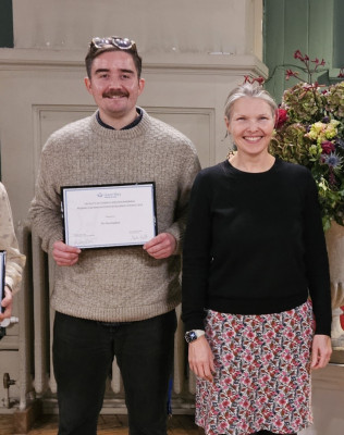 click/tap to enlarge this image... Hazel congratulating Tim (on the left) for his best PDRA award.