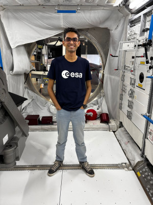 Mitansh Choksi in a mockup ISS module